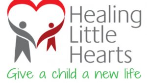 The logo of the charity Healing LIttle Hearts, showing two children with their arms joined into a heart and their slogan 'give a child a new life'