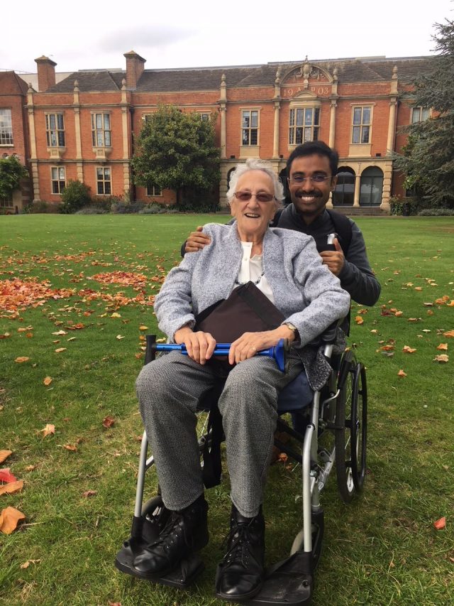 Pat Harris in wheelchair with Aaron Maniam - college grounds