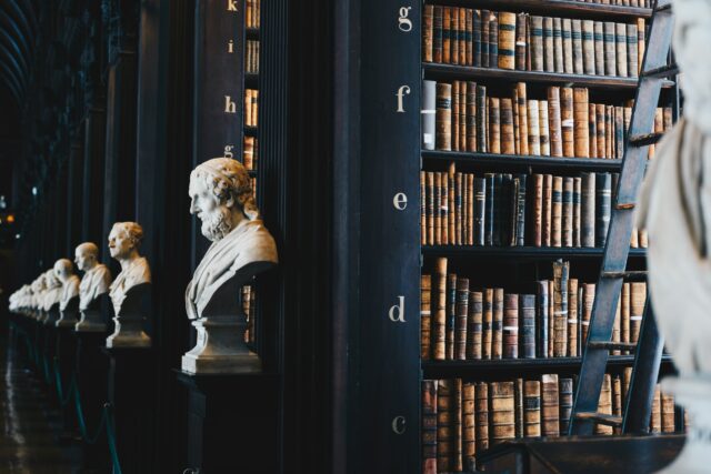 Busts of lawyers by shelves of books