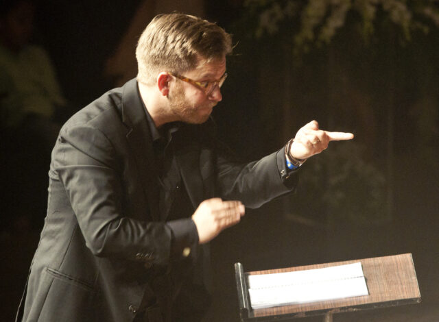 Somerville College Choir Director Will Dawes conducting