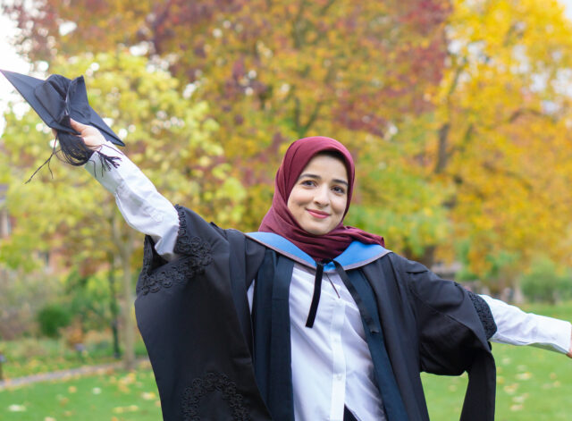 A portrait of Dr Marwa Biala in her sub-fusc on the Somerville quad