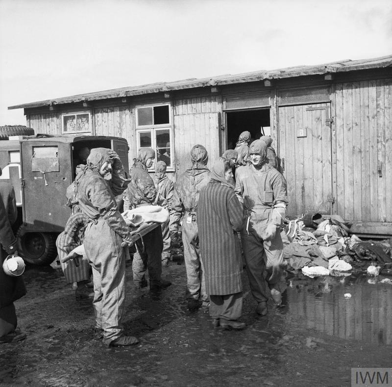 British medics evacuating inmates from one of the huts at Bergen-Belsen. Copyright: © IWM.