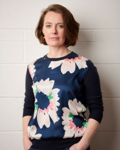 A white woman with a brown bob looks directly into the camera.