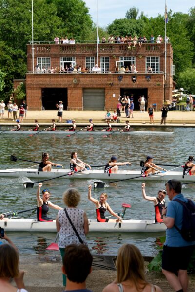 A crew celebrating in their boat on the river