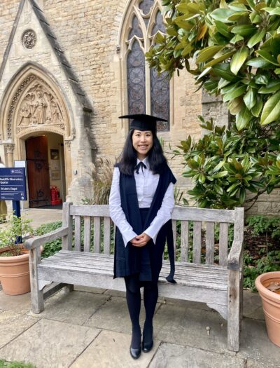 A young woman in academic dress, in Oxford.